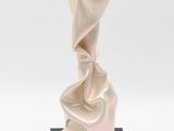 sculpture of a white cloth draped over a black base on a white background