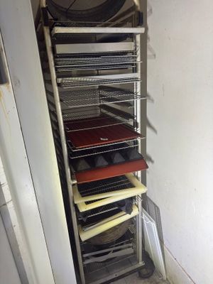 an image of a rack of pizzas in a kitchen