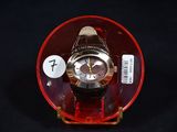 a watch in a red case on a black background