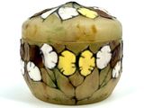 a small box with flowers on it on a white surface