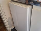 an image of a small kitchen with a stove and refrigerator