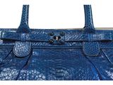 a close up of a blue handbag on a white background