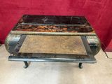 une vieille table basse avec un plateau en marbre et des pieds en métal