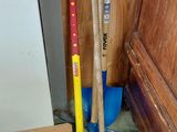 two brooms and a broom on the floor next to a door