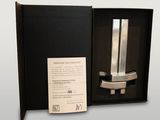 a black box with a silver knife inside of it