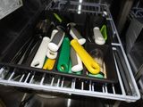 a dishwasher that has a rack with utensils in it