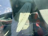 a man sitting in the back seat of a car with a hat on