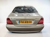 a silver car that is parked in a white room