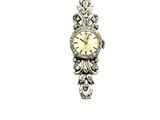 a silver clock hanging from a chain on a white background