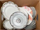 a cardboard box filled with plates and bowls in it