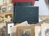 many old photographs of men and women on the table
