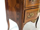a small wooden chest of drawers on a white background