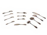 several spoons and forks are arranged in a circle on a white surface