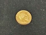 a gold coin with a picture of a man on it