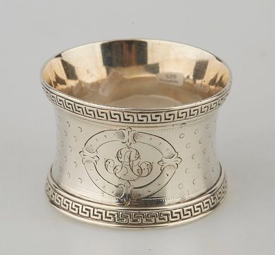 an antique silver plate with a design on the rim