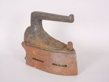 an old iron is sitting on a white surface with a white background