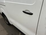 a white van parked in a parking lot with its door open