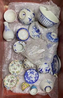 a lot of blue and white dishes and cups in a box