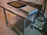 a table with a pan on it in a kitchen