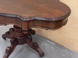 a table that has a wooden top on it