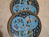 three decorative plates are sitting on the floor next to each other