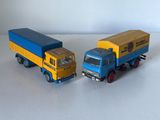 deux camions miniatures posés côte à côte sur une surface blanche