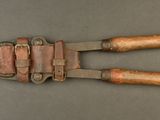 an old pair of tonges with wooden handles on a table