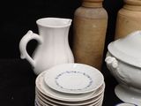 a lot of dishes and cups on the table