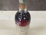 a bottle of liquor sitting on a wooden table