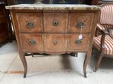 a marble top chest of drawers in a room