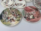 many plates with pictures of people on them on a table