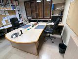 a desk with a chair and a computer on it