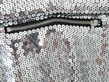 a close up of a sequinized purse with a zipper