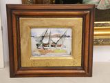 painting of a sailboat in a golden frame with a mirror in the background