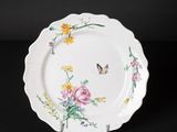 a close up of a plate with flowers and butterflies on it