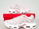 the nike air max plus is a white and pink sneaker