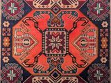a red and blue rug with a pattern on it