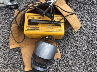 a box with a computer mouse and other items on the ground