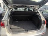 a trunk of a silver car with its doors open