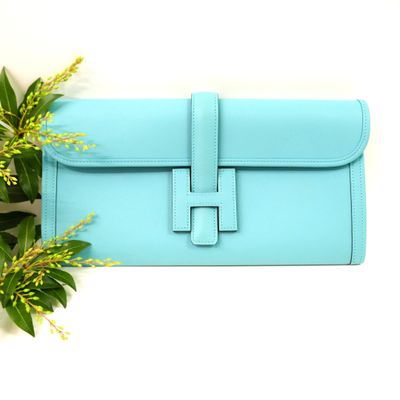 a blue purse with a flower on top of it