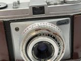 a brown leather case with a camera on top of it