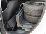 a car with a tire in the back of it
