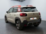 the rear of a beige citrole parked in a garage