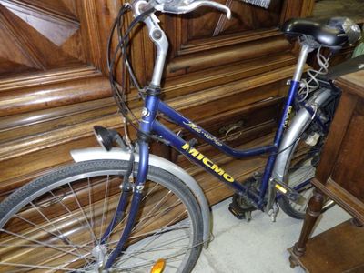 a bike that is parked in front of a piano