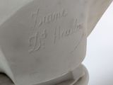 a close up of a white vase with writing on it