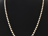 un collier de perles sur un mannequin, un mannequin, un mannequin, un mannequin, un mannequin, un mannequin