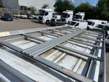 many trucks parked in a parking lot near a building
