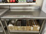 a metal table with several boxes of beer on it
