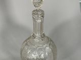 a glass bottle that is sitting on a table