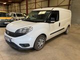 the white van is parked in a garage with other cars